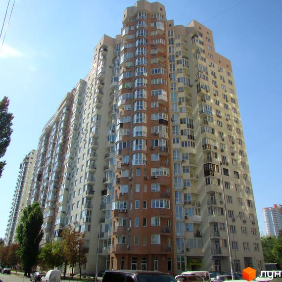 Житловий комплекс на вул. Червоноткацька, 43, з фасадом з балконами та великими вікнами. Прибудинкова територія озеленена деревами та кущами.