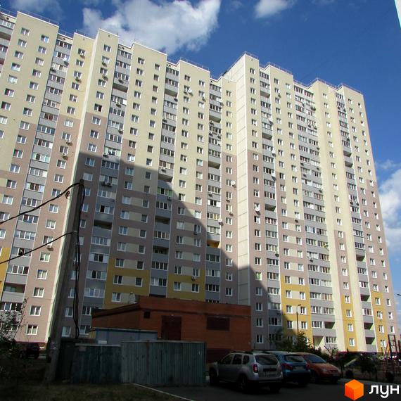 Житловий комплекс Милославичі з висотними будинками та прибудинковою територією, що включає парковку та зелені зони.