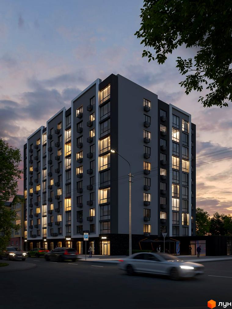 Будинок житлового комплексу Комфорт Сіті з великою кількістю вікон та кондиціонерів, освітлений вечірнім світлом. Перед будинком розташована дорога з автомобілями та пішохідна зона.