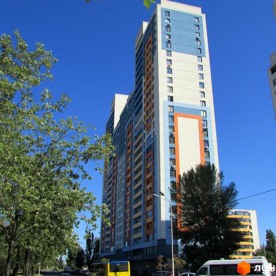 Житловий комплекс Богатирський з сучасним фасадом та прибудинковою територією, озелененою деревами.