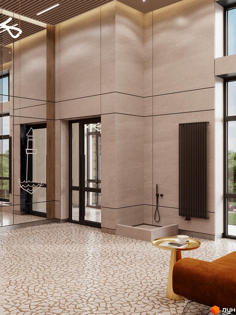 Інтер'єр вхідної групи Житлового комплексу River Port з оздобленням стін під камінь та мозаїчною підлогою.