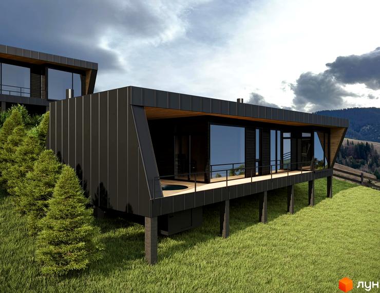 Зображення Котеджного містечка Emshir Villas: будинок з великими вікнами та дерев'яною терасою на зеленій галявині.