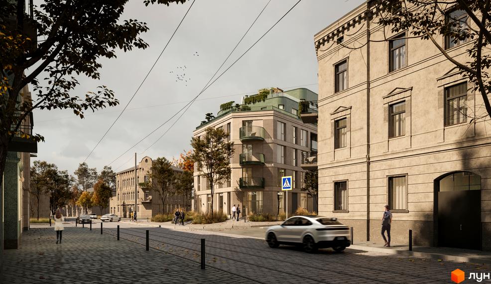 Зображення фасаду будинку Житлового комплексу D2 та прилеглої території. На передньому плані дорога з бруківки.