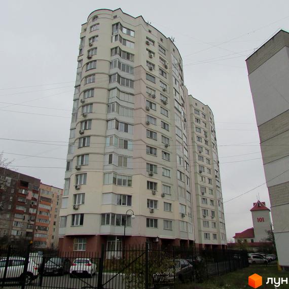 Житловий комплекс Оваціо з сучасною архітектурою та прибудинковою територією, що включає паркувальні місця.