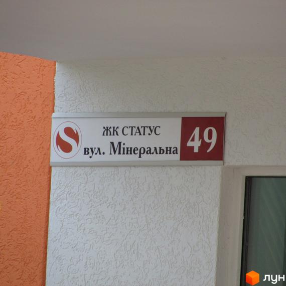 Житловий комплекс Status, вулиця Мінеральна, 49. Зовнішній вигляд будівлі з вивіскою.