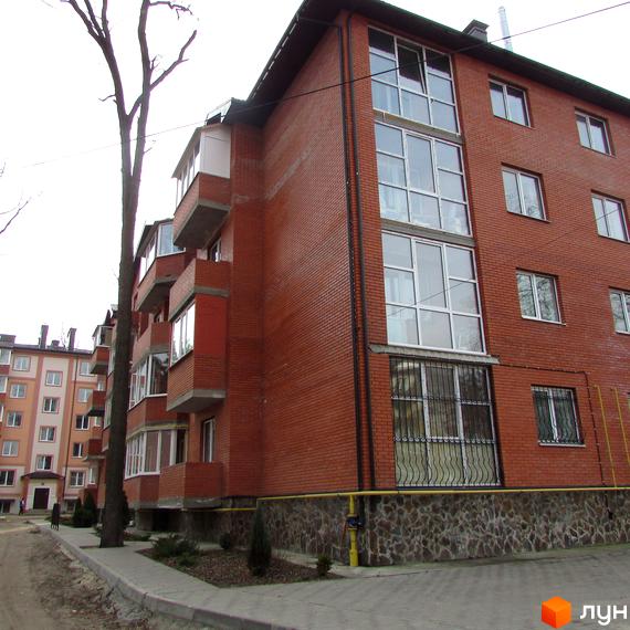 Житловий комплекс Креатив Хаус – цегляна новобудова з великою кількістю вікон та балконів. Поруч розташована прибудинкова територія з деревами та тротуаром.