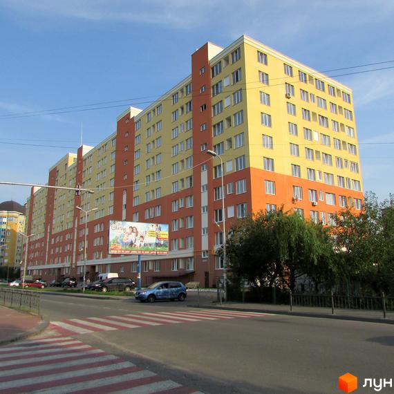 Зображення фасаду багатоповерхового будинку Житлового комплексу Вишневий затишок. На передньому плані дорога з пішохідним переходом.