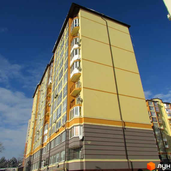 Новобудова Житлового комплексу Французький квартал: висотний будинок з бежевим фасадом, балконами та темно-сірим цоколем.