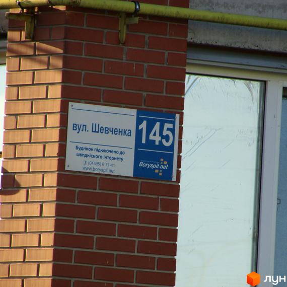 Будинок №145 на вулиці Шевченка. На фасаді розміщено табличку з адресою та інформацією про підключення до інтернету від Boryspil.net.
