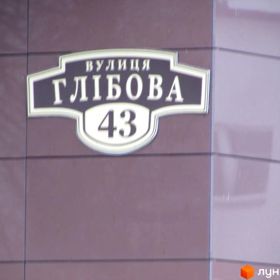 Назва вулиці та номер будинку Глібова 43 на фасаді будівлі. Зовнішній вигляд новобудови ЖК Зірка Дніпра.
