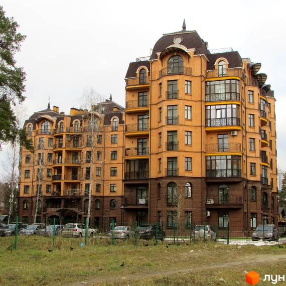 Житловий комплекс Соборний - це багатоповерхова цегляна новобудова з архітектурними елементами у вигляді башт та куполів. Перед будинком розташована парковка та зелена зона з деревами.