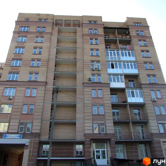 Житловий комплекс на вул. Шевченка, 4, має кілька поверхів з великими вікнами та балконами. Прибудинкова територія облаштована для комфортного проживання.