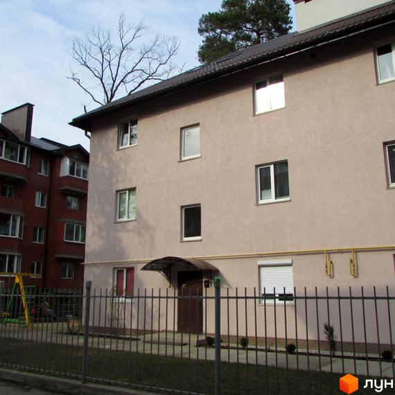 Житловий комплекс на вул. Варшавська, 95. Будинок з світлою фасадною обробкою та прибудинковою територією.