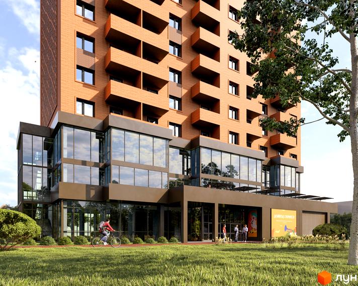 Новобудова Boryspil Residence з фасадом з цегли та панорамним склінням. На території житлового комплексу газон та зелені насадження.