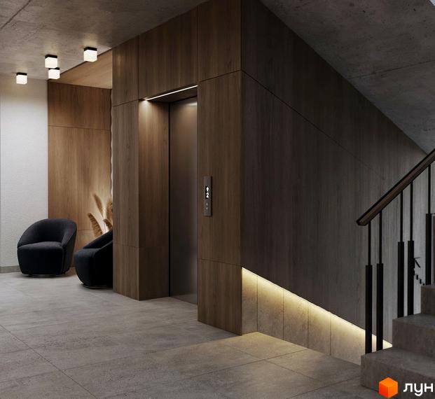 Інтер'єр холу в ЖК SVOЇ PARKHOUSE з ліфтом, кріслами та сходами. Стіни оздоблені деревом, підлога з плиткою, освітлення вбудоване.