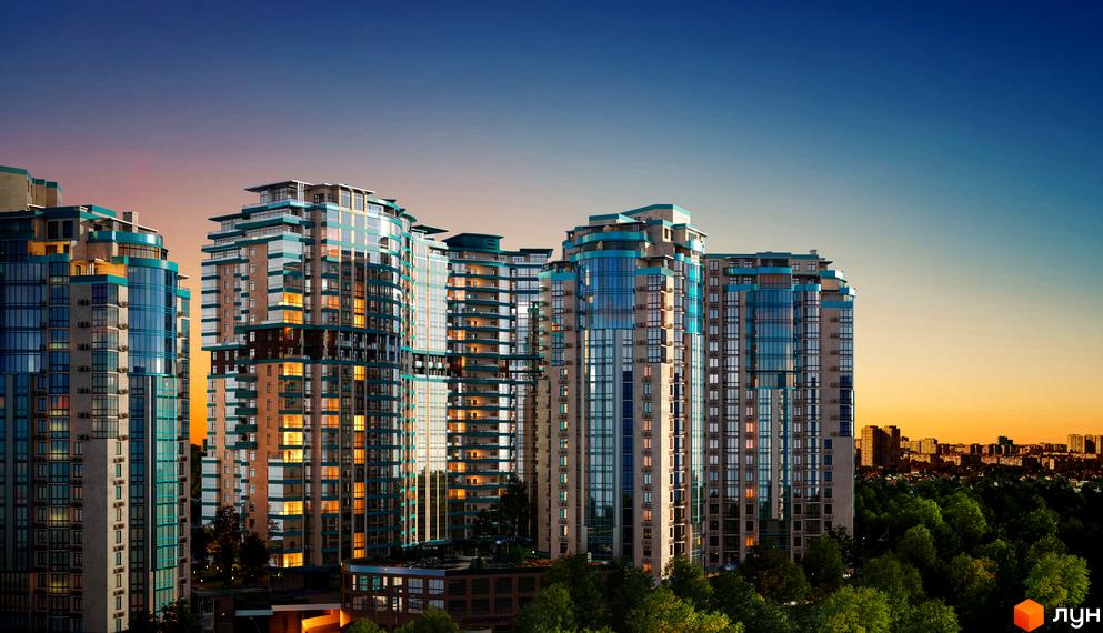 Житловий комплекс Aqua Marine з панорамними вікнами на тлі вечірнього неба. Високі будинки з блакитними вставками та ліхтарями у вікнах.