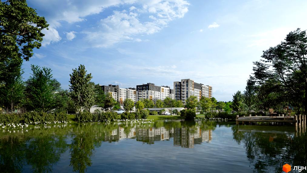 Житловий комплекс Сімейний COMFORT 2 з озером та зоною відпочинку біля водойми. Сучасні багатоповерхові будинки з різнокольоровими фасадами.