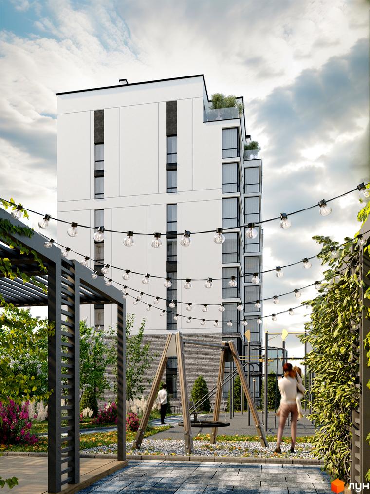 Сучасний житловий комплекс Перемога з білим фасадом та скляними елементами. Прибудинкова територія з дитячим майданчиком та зеленню.