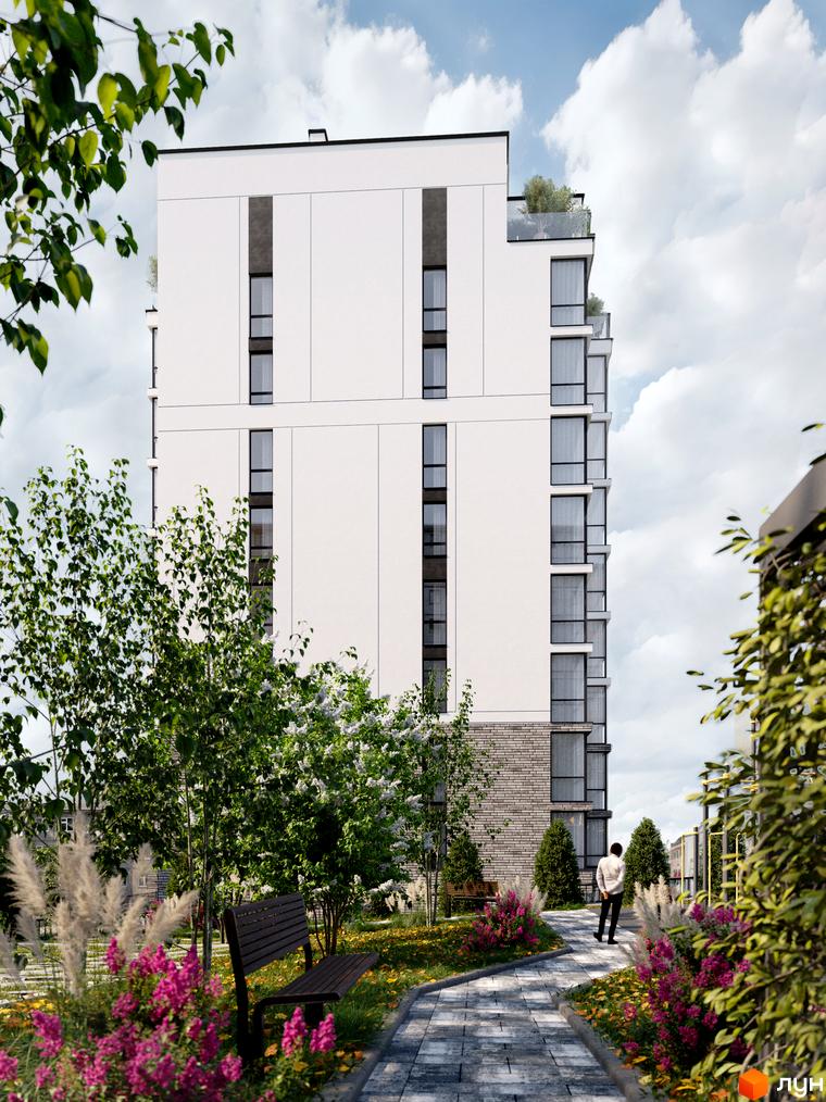 Новобудова ЖК Перемога з білим фасадом та скляними балконами, оточена зеленню та квітковими клумбами.