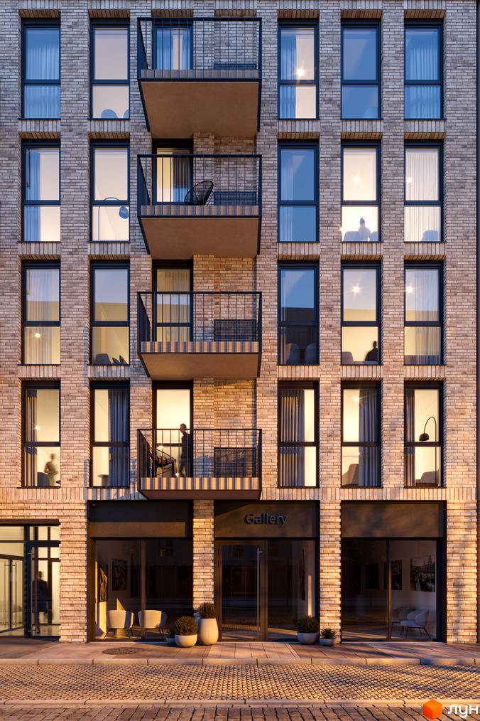 Фасад житлового комплексу Avalon Yard з цегляним оздобленням та балконами. Біля будинку розташована бруківка та зелені насадження.