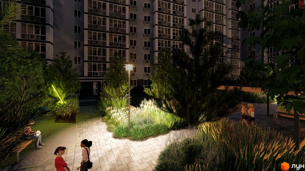 Житловий комплекс НЕЗАЛЕЖНІСТЬ: фасади багатоповерхових будинків та освітлена прибудинкова територія з зонами відпочинку та озелененням.