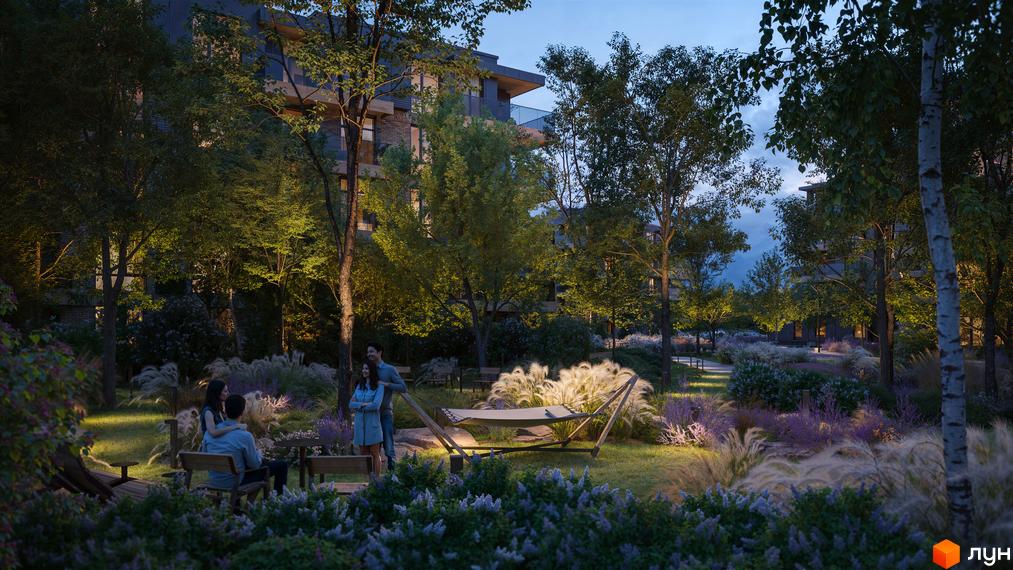 Житловий комплекс Park House з вечірнім освітленням. На території комплексу розташовані дерева, газон, лавки та гамак.