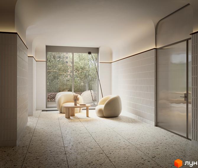 Інтер'єр холу в житловому комплексі Kub29 з м'якими кріслами, журнальним столиком та скляними дверима. Світле приміщення з великими вікнами та тераццо підлогою.