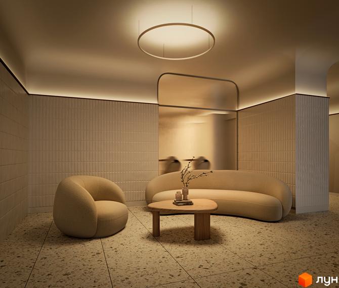 Інтер'єр житлового комплексу Kub29: світла вітальня з м'якими меблями, круглим світильником та декоративними стінами.