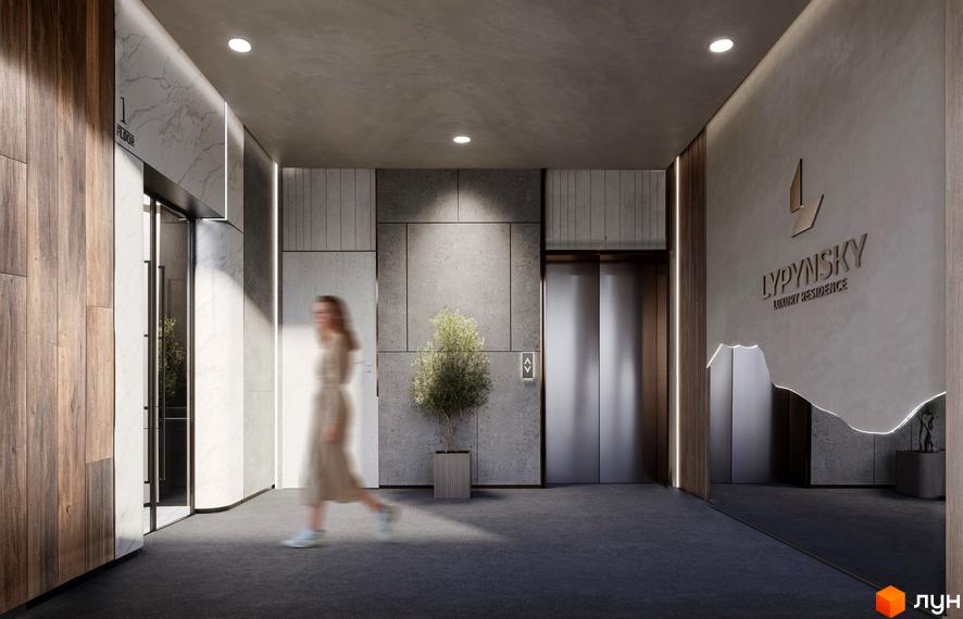 Холл житлового комплексу Lypynsky з ліфтом та оздобленням з дерева і бетону. У просторому холі видно людину, що проходить повз.