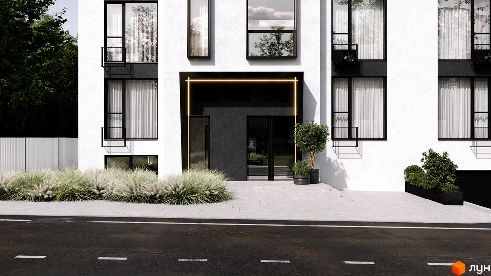 Фасад житлового комплексу COLIVING ONE з великими вікнами та входом, оточений зеленню та травою. Прибудинкова територія з дорогою та тротуаром.