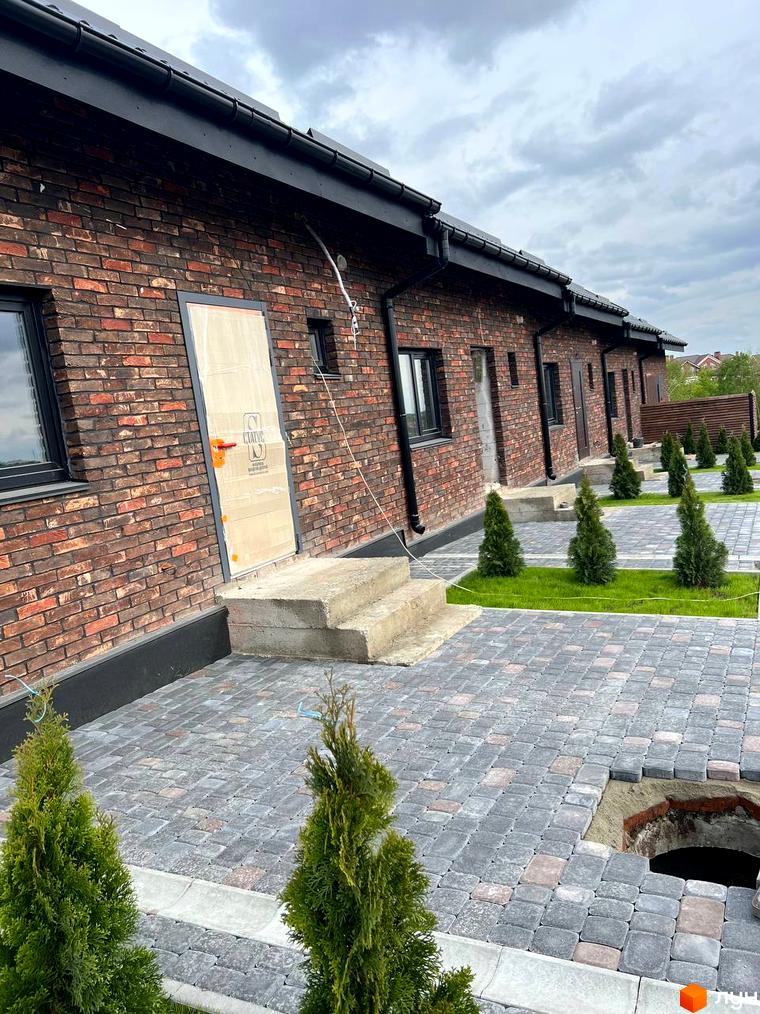 Котеджне містечко Квартал Баварія: фасади з цегли та вимощені доріжки з туями. Зовнішній вигляд будівельного проєкту та прибудинкової території.