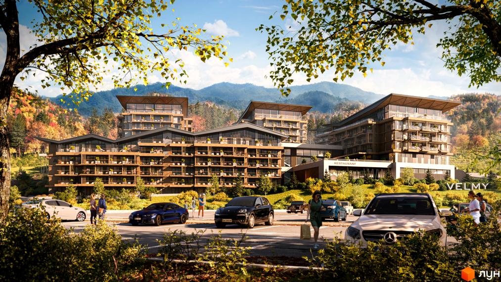Апарт-готель VELMY з багатоповерховими корпусами та балконами, розташований серед гірського ландшафту з автомобілями на парковці.
