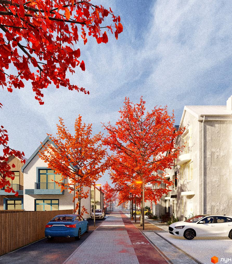 Таунхауси Sвій Dім 3 з яскравим осіннім листям на деревах та сучасними фасадами будинків. Навколо зелені насадження, доглянута прибудинкова територія та зручні вулиці.