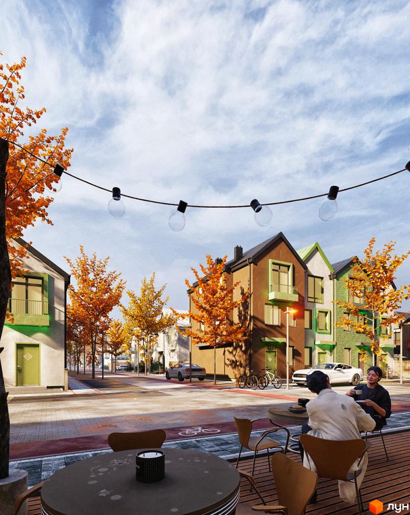 Таунхауси Sвій Dім 3: фасади будинків з оранжевим та зеленим оздобленням, розташовані вздовж вулиці з деревами восени. Тераса з столиками та людьми на передньому плані.