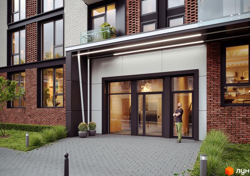 Клубний будинок Sapfir із цегляним фасадом та великими вікнами. Біля входу облаштований простір із газоном та освітленням.