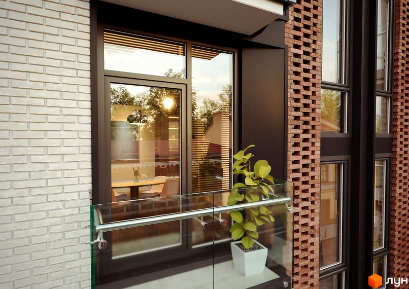 Клубний будинок Sapfir. Зовнішній вигляд будівлі з цегляним фасадом та великими вікнами, що відображають зелень дерев.