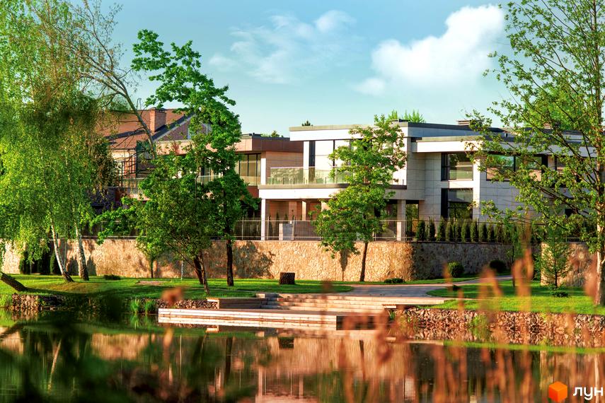 Котеджне містечко DAMBA RIVER PARK з сучасними будинками та доглянутою прибудинковою територією біля води. На території є зелені насадження та водойма з відображенням будинків.