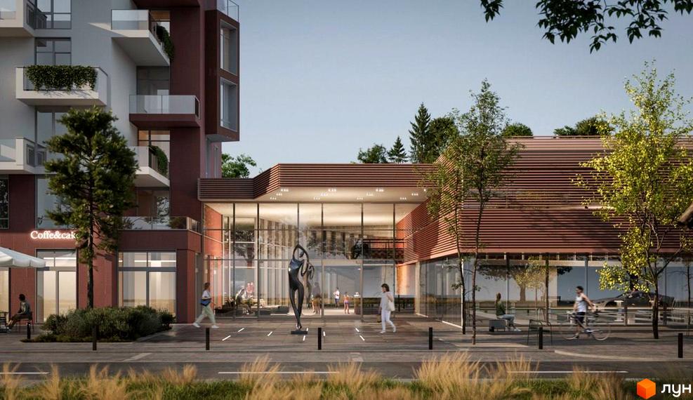 Просторий житловий комплекс з червоними фасадами та скляним входом. Територія перед будинком облаштована зонами відпочинку та озелененням.