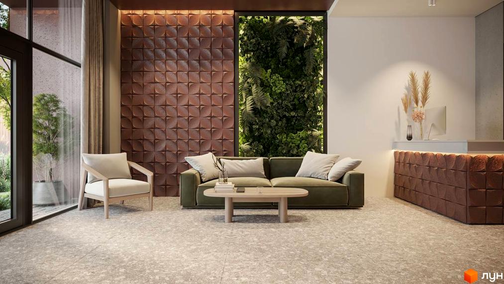 Інтер'єр лобі житлового комплексу Prostir з диваном, кріслом та стійкою ресепшн. Зелена стіна з рослинами та коричнева панельна стіна створюють затишну атмосферу.