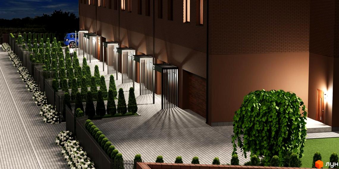 Зображення фасаду та прибудинкової території Житлового комплексу Обрій в темну пору доби. Висаджені декоративні дерева та кущі вздовж тротуару.