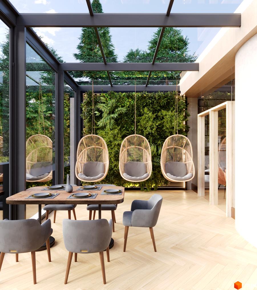 Апарт-готель VERTEXVILLE з панорамним склінням та зеленою стіною, що виходить на дерева. Зона відпочинку з плетеними кріслами-гойдалками та обіднім столом.