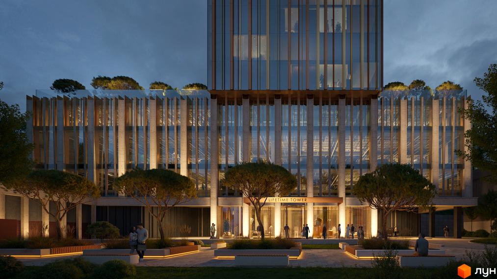 Зовнішній вигляд THE ONE Tower з підсвіченим фасадом та ландшафтним дизайном прибудинкової території. Комплекс з елегантними вертикальними елементами та скляними фасадами.