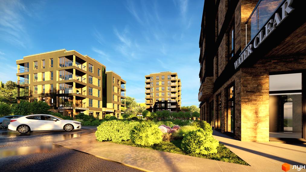 Житловий комплекс River Rika з цегляним фасадом та скляними балконами. Навколо комплексу розташовані зелені насадження та доглянута прибудинкова територія.