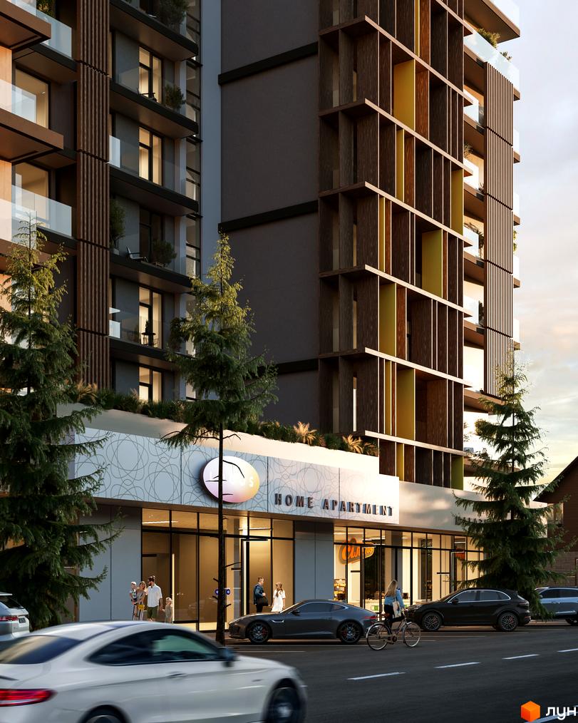 Фасад житлового комплексу Logos Home Apartment з дерев'яними елементами та скляними балконами. Перед будинком розташована прибудинкова територія з деревами та дорогою.