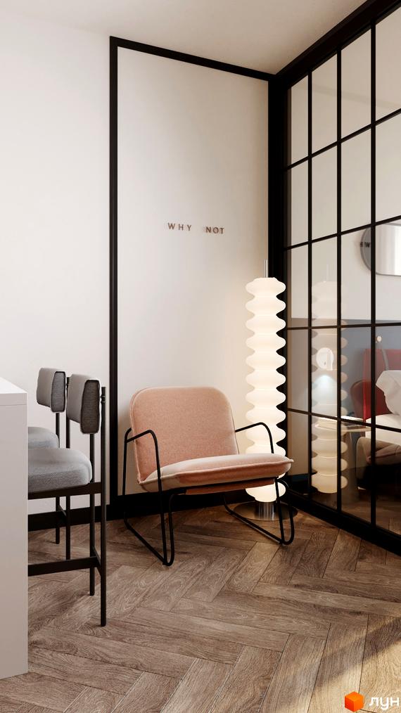 Інтер'єр квартири в апарт-готелі. Світла кімната з м'яким кріслом, підлогою з дерев'яним візерунком та скляною перегородкою.