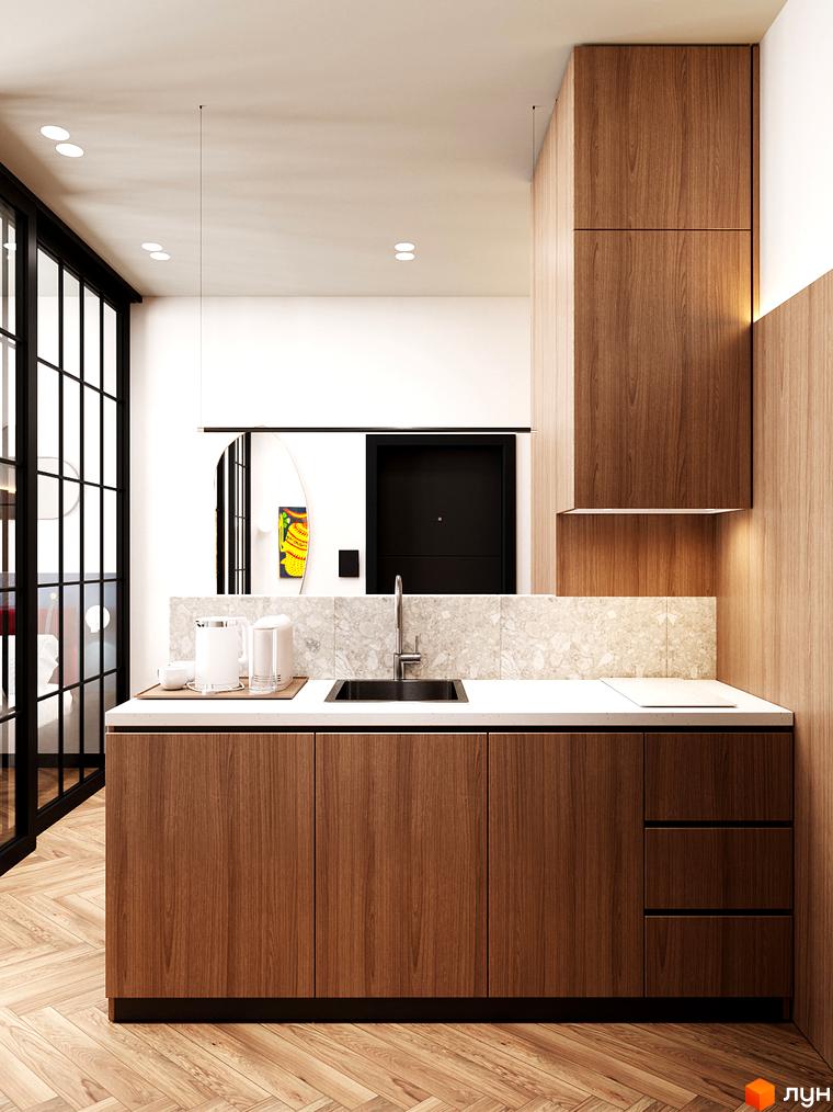 Інтер'єр кухні в апарт-готелі WOL Vinnytsia. Дерев'яні фасади кухонних меблів, світла стільниця та стіна з мармуровою плиткою.