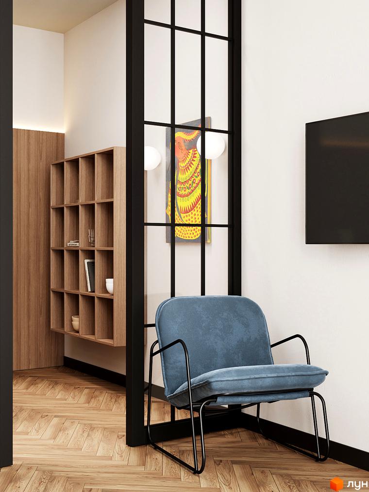 Інтер'єр апартаментів в Апарт-готелі WOL Vinnytsia: блакитне крісло, дерев'яні меблі, картина на стіні та паркетна підлога.
