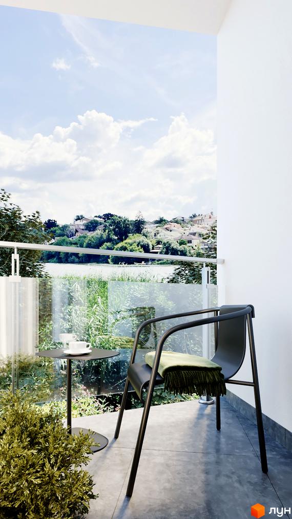 Затишний балкон апарт-готелю WOL Vinnytsia з видом на мальовничу природу. На балконі столик з чашкою кави та крісло з пледом.