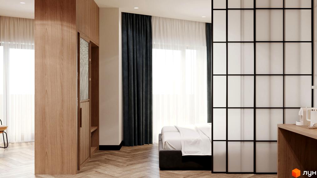 Інтер'єр апартаментів в апарт-готелі WOL Vinnytsia. Спальня з великим ліжком, перегородкою та дерев'яними меблями.