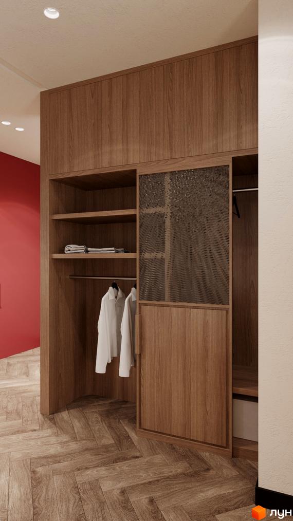 Інтер'єр апартаментів в Апарт-готелі WOL Vinnytsia. Шафа з дерев'яними фасадами та скляними вставками, одяг на вішалках.